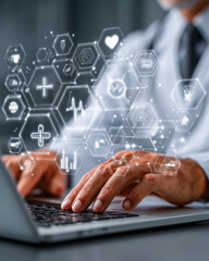Doctor using laptop computer with medical icons on screen. Medicine and healthcare concept.