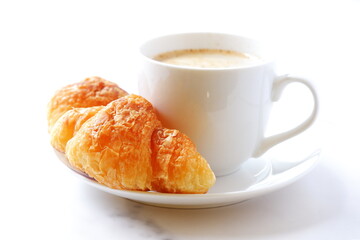 Cup of coffee and croissants
