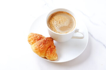 Cup of coffee and croissants
