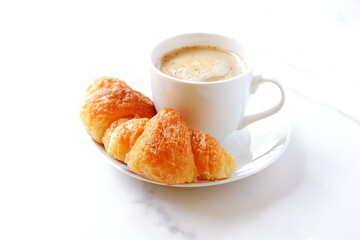Cup of coffee and croissants
