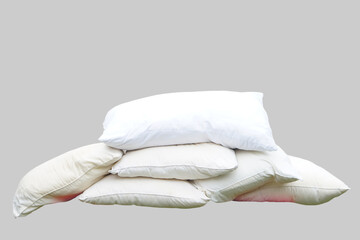 Stack of used white pillows without pillowcases, isolated on grey background. Concept, equipment in bedroom. Hygiene, cleanliness, and regular maintenance of pillows for better health.         