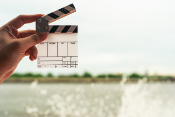 Conservationists hold up film posters with nature and rivers as backdrops, suggesting the importance of conservation efforts that should be made.