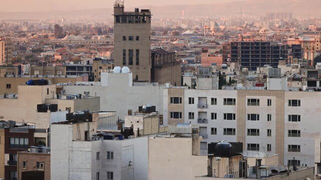 Panoramic view of the roofs of Shiraz, sunrise over the city, against the backdrop of mountains. a city in southern Iran, a center of culture and nuclear research. Shiraz is a city of poetry, wine and