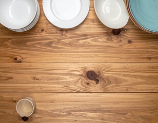 Top-down view of dishes arranged along the edge of a wooden table, with empty space in the center for text