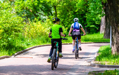 Fototapeta premium Cyclists ride on the bike path in the city Park 