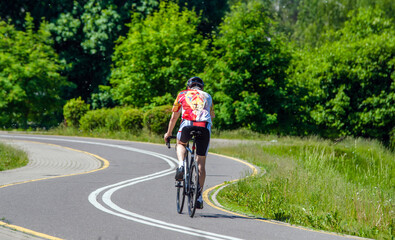 Fototapeta premium Cyclist ride on the bike path in the city Park 