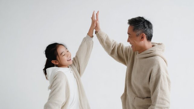 Father and teen celebrating connection with high five gesture
