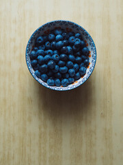 Fresh Blueberries in a Decorative Bowl on Wooden Table