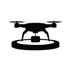 Silhouette of a drone landing on a circular platform with a camera