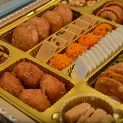 Delicious sweet treats including cakes, candies, and desserts beautifully styled with soft lighting and shallow depth of field