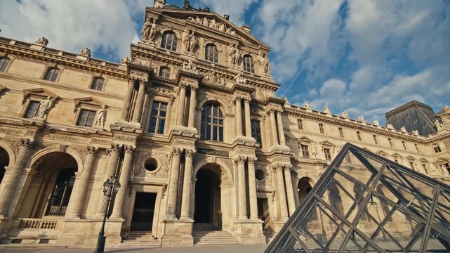 Famous Louvre Museum in Paris city center with tourists exploring cultural landmarks and beautiful European architecture in the historical district of France