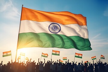 Proud crowd celebrates nationhood under a vast Indian flag waving majestically against a clear blue sky at sunset