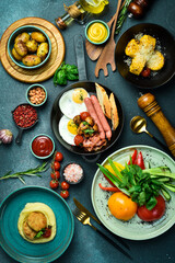 Food. Set of dishes and spices on the table, table setting, dining table. On a dark stone background. free space for text.