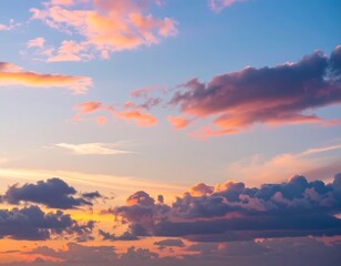 Obraz premium Dreamlike sky panorama with pastel hued clouds illuminated by the warm glow of sunset