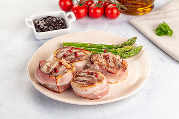 Tasty grilled pork medallion with bacon