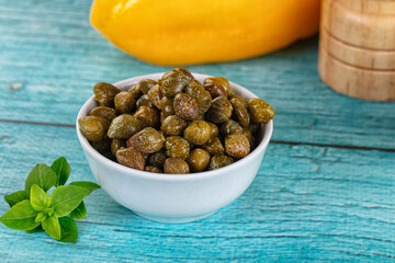 Pickled canned capers in the bowl