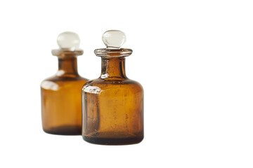 Two brown vintage apothecary bottles with glass stoppers on transparent background