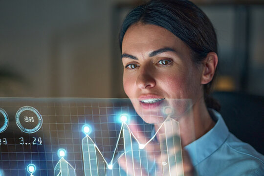 Professional woman analyzing futuristic data projections, focusing on glowing graphs and numeric displays. Highlighting technology, business growth, and innovation.