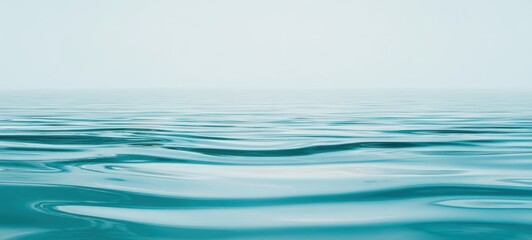Naklejka premium The serene ocean surface reflecting a tranquil sky and endless horizons.
