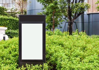 Mock up white vertical light box billboard on black stand pole. Clipping path for mockup