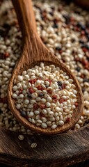 Wooden spoon holding a mixture of white, red, and black seeds