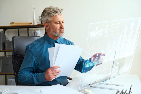 Professional business analyst working with futuristic digital interface, analyzing data and graphs on a transparent screen in a modern office environment. Inspired by innovation and technology