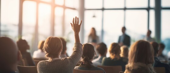 The audience member raises a hand during an engaging business conference session.