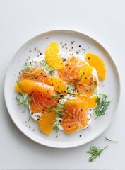 Plate of orange slices, dill, and salmon on a creamy base
