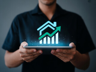 Real Estate Growth Concept – Holographic House with Bar Chart and Arrow on Digital Tablet. businessman holding a house with a graph