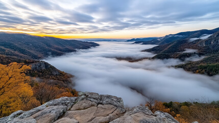 Fototapeta premium Majestic valley shrouded in cloud inversion, showcasing autumn foliage and serene landscape