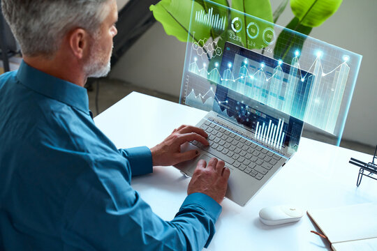 Business man Analyzing Data on a Holographic Screen with Modern Technology Interface concepts of augmented reality, data analysis, or tech-driven processes in a business or work environment.