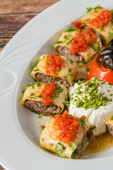 Beyti kebab rolled in lavash with yogurt, tomato sauce and grilled tomato
