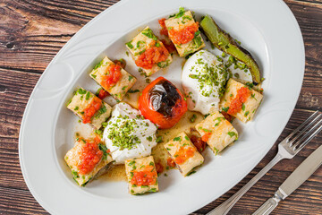 Beyti kebab rolled in lavash with yogurt, tomato sauce and grilled tomato