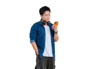 A young man engrossed in his phone, with headphones resting on his shoulders on png background