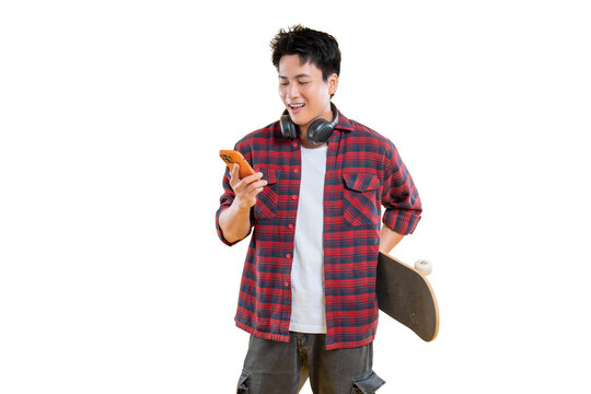A young man uses a phone in a casual setting, holding a skateboard and wearing headphones on png background - Powered by Adobe
