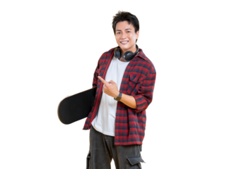 A young man pointing with a skateboard in hand and headphones around his neck, smiling broadly and appearing cheerful on png background