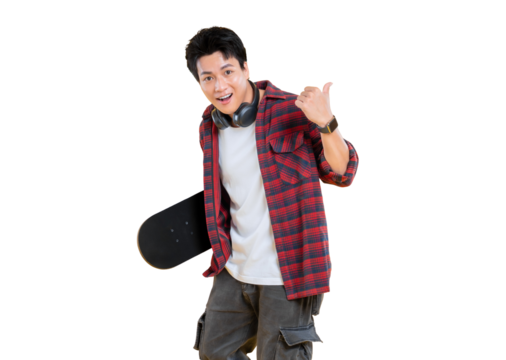 Happy young man in stylish outfit posing with skateboard and giving thumbs up. He is wearing headphone on png background