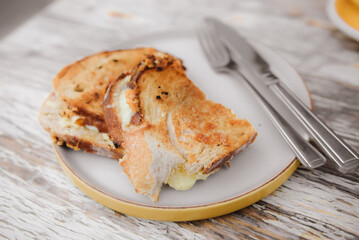 Cheese sandwich and grilled ham on a table in cafe.