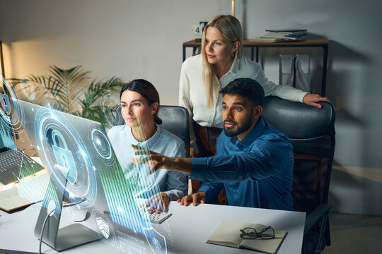Team Collaboration On Cybersecurity Solutions With Holographic Graphics, Highlighting Technology, Innovation, And Progress In A Modern Workplace Setting, Depicting Digital Interfaces, 