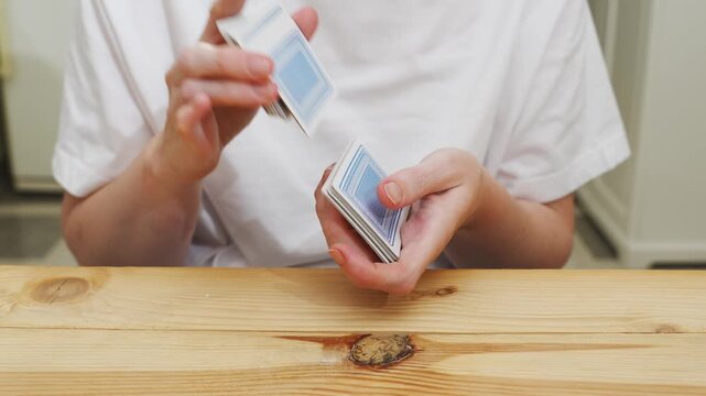 hands shuffle a deck of playing cards. gambling. A board game for spending leisure time with friends and family.