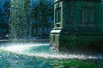 Refreshing fountain, showcasing the interplay of water and stone. Water cascading from the fountain structure, creating a dynamic display in the city © Leilani
