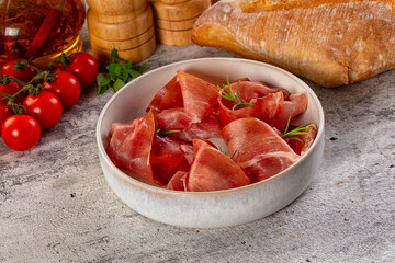 Spanish dry jamon serrano pork meat slices