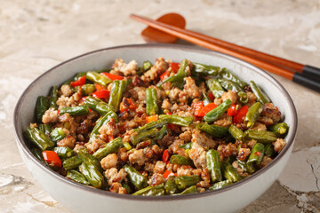 Asian food stir-fried green bean with minced pork closeup in the bowl on the table. Horizontal