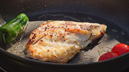 fresh fish fillet on hot pan