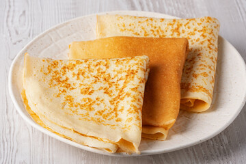 Freshly cooked pancakes on a wooden white table
