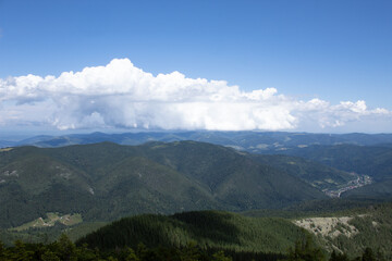 Expansive Carpathian mountain panorama with endless forested ridges and dramatic cloud formations