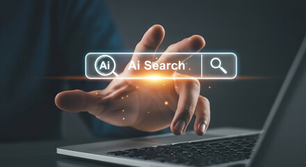 A person's hand interacts with a glowing AI search bar displayed over a laptop keyboard.