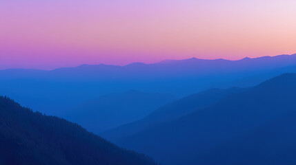 Obraz premium Mountain landscape bathed in twilight hues of deep blue and fading sunset colors.