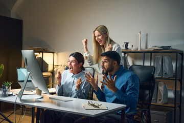 Professional team celebrating success in a modern office with passion and excitement, illustrating teamwork, achievement, and motivation in a collaborative business environment