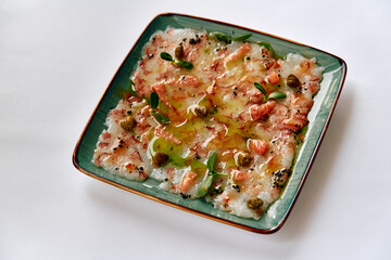 A Delicate Plate of Seafood Carpaccio Garnished with Fresh Herbs and Drizzled with Olive Oil, Showcasing a Truly Gourmet Culinary Experience